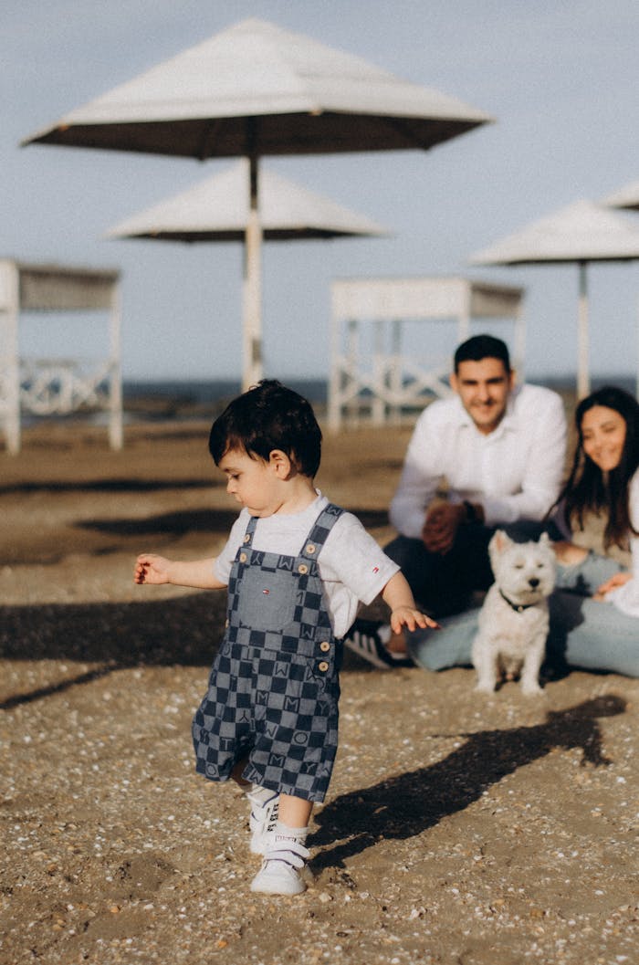 A sunny day at the beach in Baku, Azerbaijan, featuring a family with a child and a dog enjoying a relaxed moment.